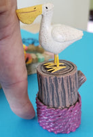 mini pelican on pier stump                    sd-gg325